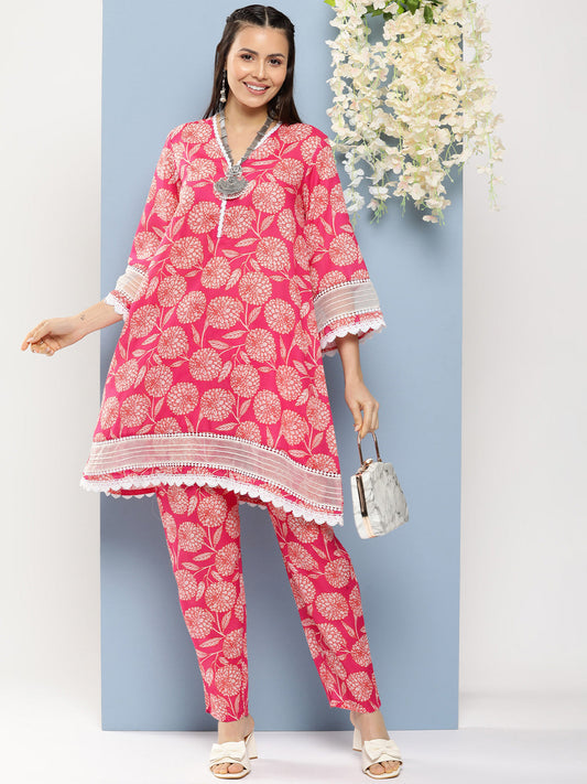 Bhama Couture Pink Floral Print A- Line Kurta With Lace Detailing & Pink Floral Print Trousers.